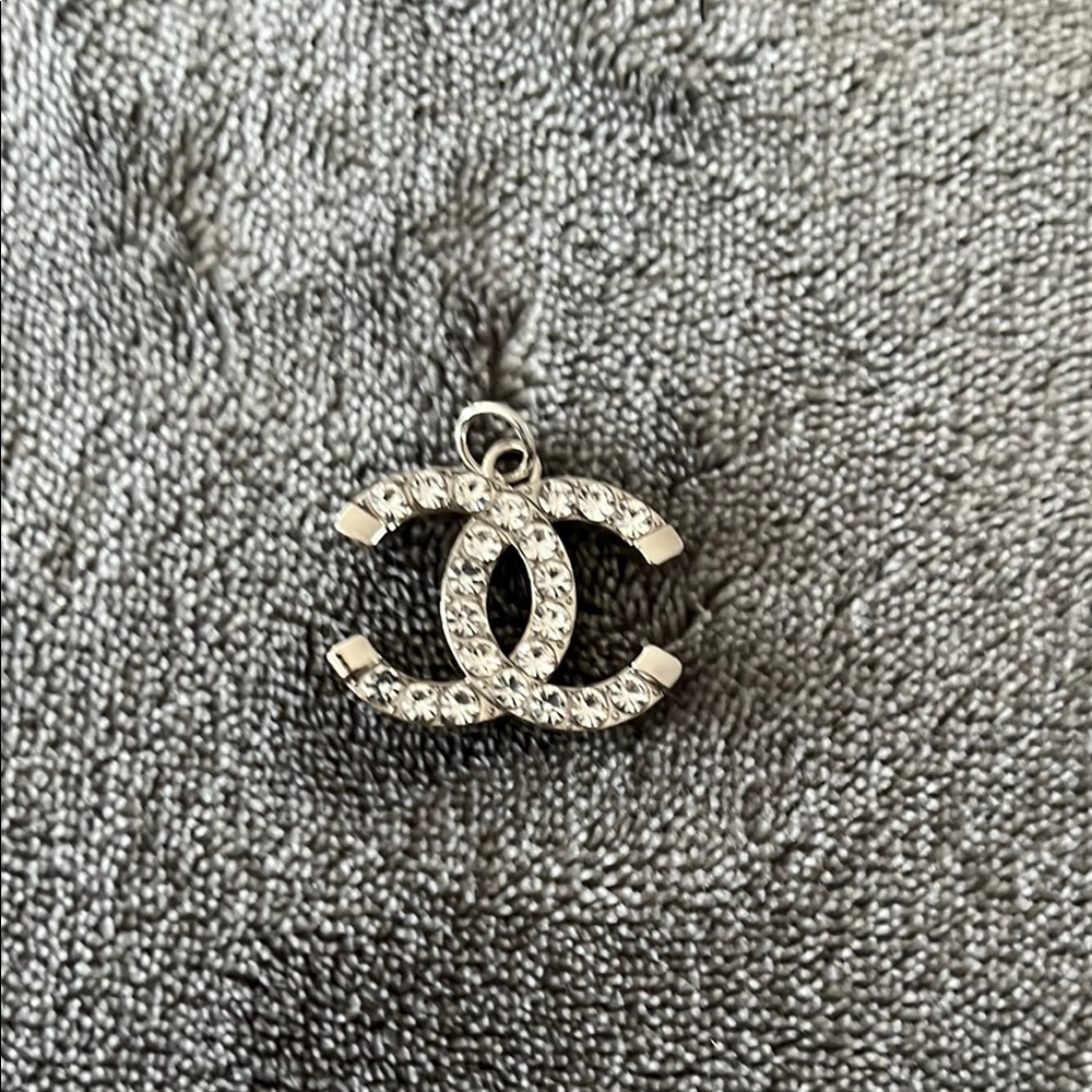 CHANEL Silver charm with Interlocking CC Logo and Gemstone Accents